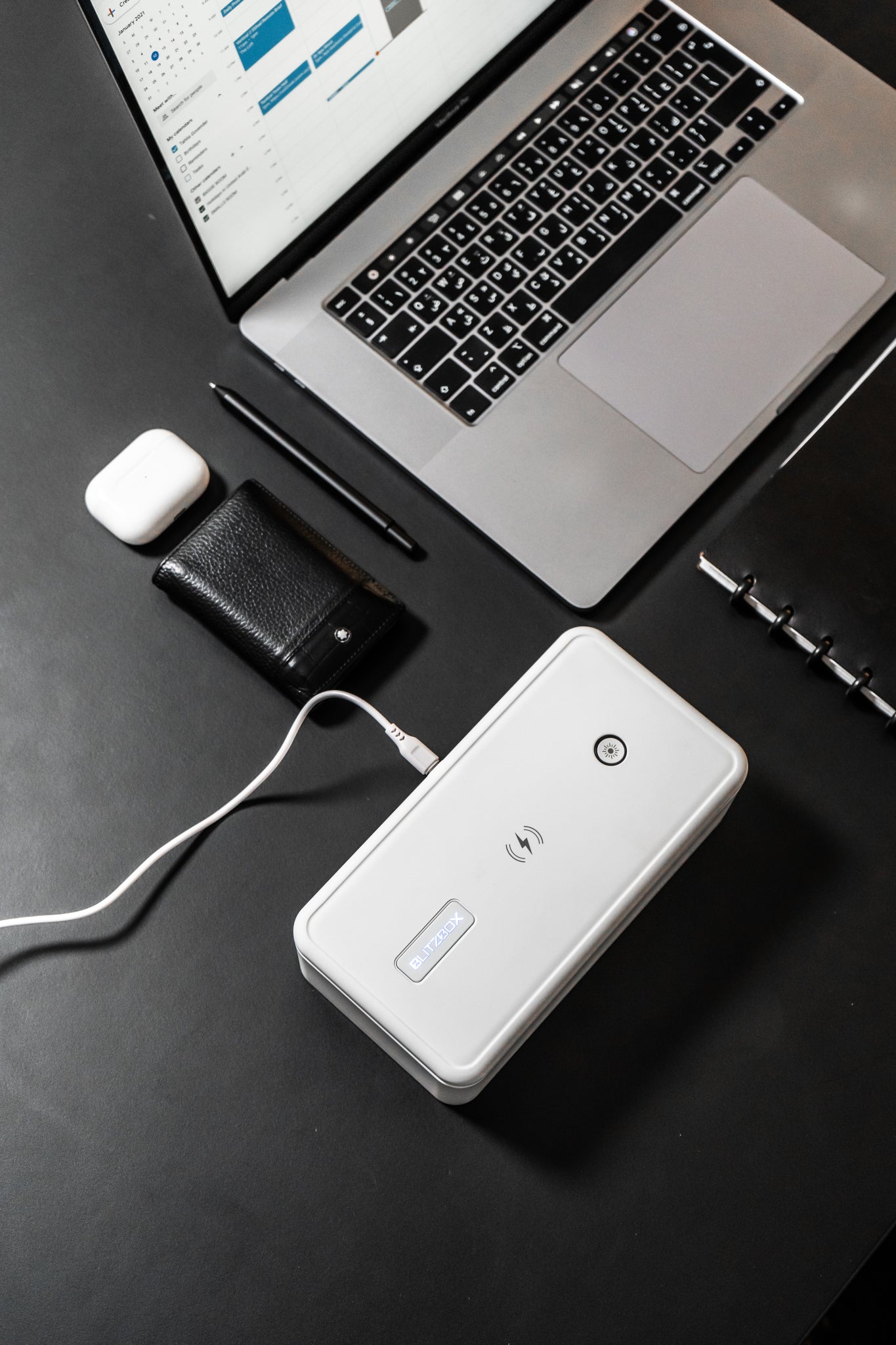 BlitzBox Pro 8 UV Phone Sterilizer on desk with Macbook and accessories